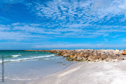 Breakwater rock barrier at the end of Bell Air beach, Florida, on a sunny and warm morning.