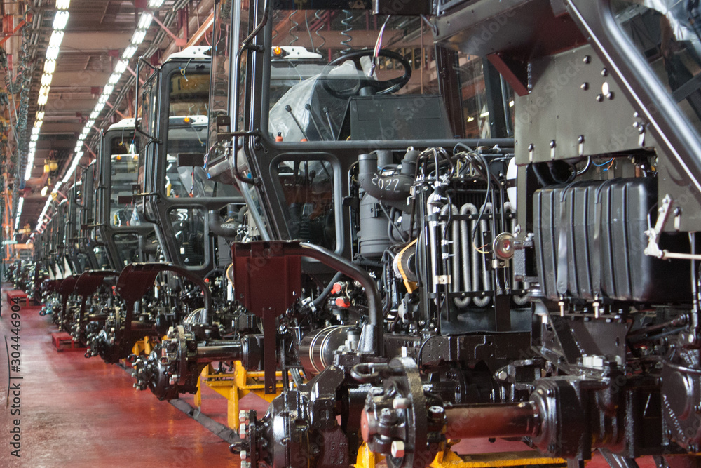 Tractor Manufacture Assembly Line Inside The Agricultural Machinery Factory. Tractor Manufacture Assembly Line Inside The Agricultural Machinery Factory.