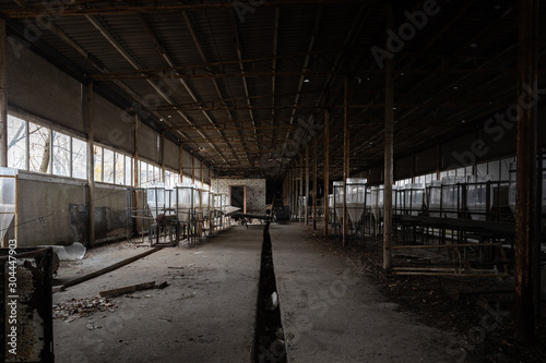 Abandoned industrial interior with breeding tanks