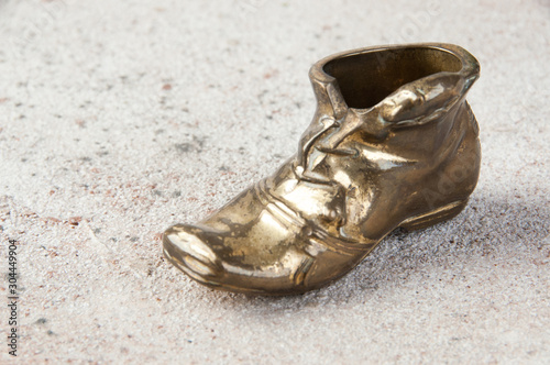 Old brass ashtray in the shape of a shoe