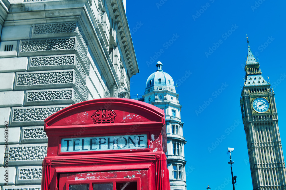 Obraz premium London phone booth with buildings and Big Ben on the background