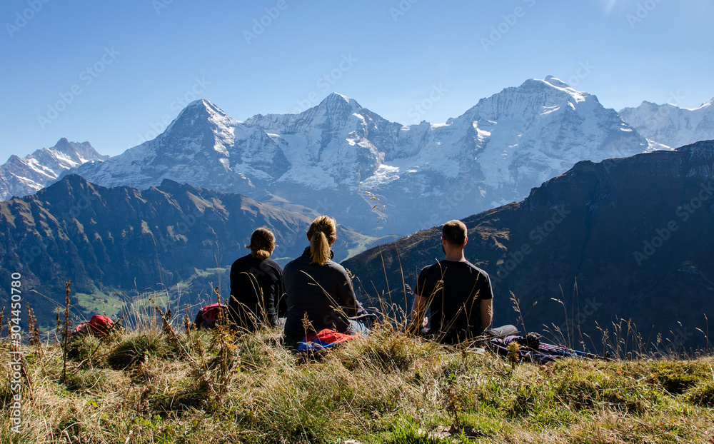 A group of hiker taking a rest and enjoy the view in the Swiss Alps