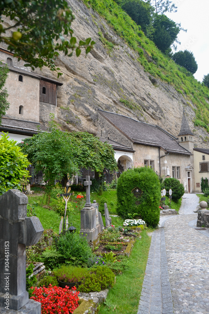 old pretty cemetery with flowers on the mountain in austria landscape