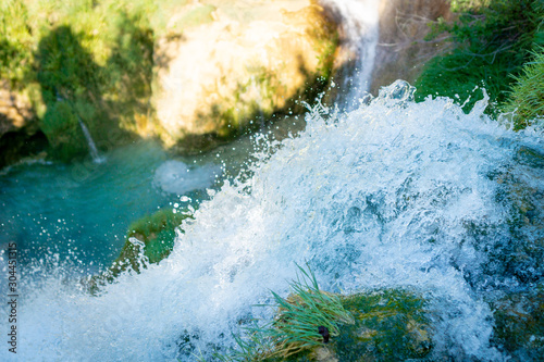 Details of drops from a waterfall in Plitvice National Park in Croatia in a sunny day in summer during vacationes, immersed in wild nature silence rocks water lakes rivers falls trees and forests