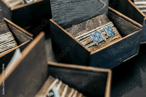 Cuadro en lienzo Silver men's cufflinks lie in wooden boxes
