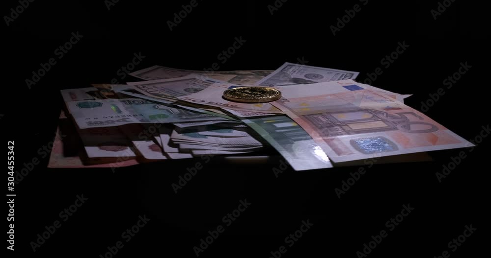 Banknotes on rotating black table, Bitcoin coin on top, dollars, euros, rubles, money from different countries, rotating abstraction, cryptotechnologies, digital, exchange, visualization of exchange Banknotes on rotating black table, Bitcoin coin on top, dollars, euros, rubles, money from different countries, rotating abstraction, cryptotechnologies, digital, exchange, visualization of exchange