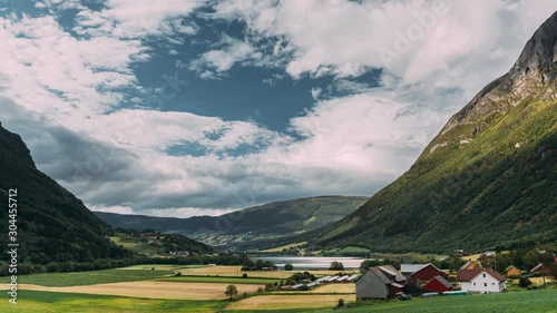 Byrkjelo Village, Sogn Og Fjordane County, Norway. Beautiful Sky Above Norwegian Rural Landscape. Bergheimsvatnet Lake In Summer Day. Agricultural And Weather Forecast Concept. Time-lapse 4k photo