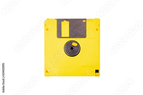 Single yellow floppy drive, old vintage diskette, asset isolated on white background, top view. Save icon concept, obsolete tech, data storing device