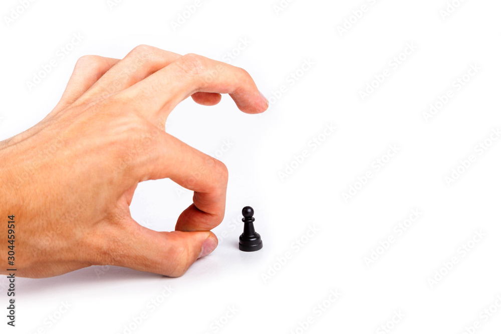 Human hand flicking a chess piece, huge hand flicks away a small tiny black pawn. Flick gesture isolated on white. Danger, anxiety and peer pressure, being fired, losing job due to layoffs concept Human hand flicking a chess piece, huge hand flicks away a small tiny black pawn. Flick gesture isolated on white. Danger, anxiety and peer pressure, being fired, losing job due to layoffs concept