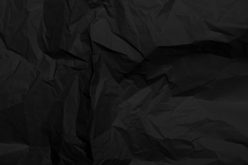 Black crumpled paper texture with folds, black background, wallpaper