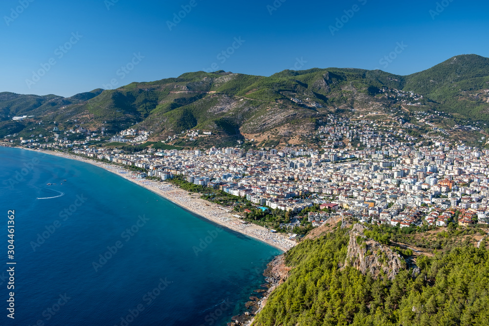 Naklejka premium Alanya, Turkey. Beautiful view from the fortress Alanya Castle of the Mediterranean Sea and Cleopatra beach at suny day. Vacation postcard background