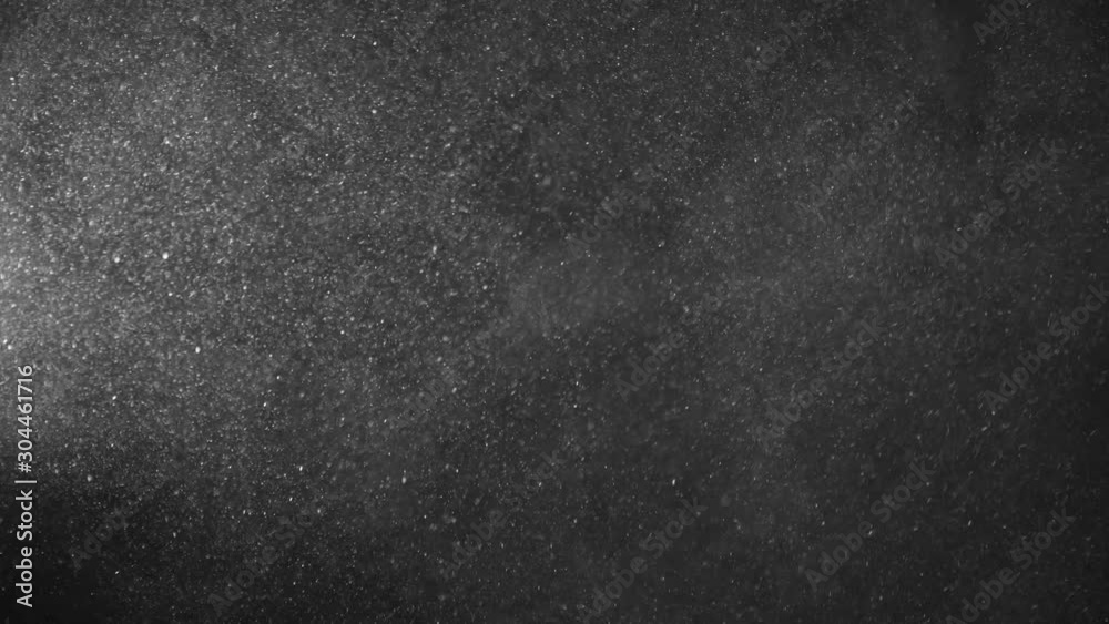 Natural Organic Dust Particles Floating On Black Background. Dynamic Dust Particles Randomly Float In Space With Fast And Slow Motion. Shimmering Glittering White Particles With Bokeh In The Air. Natural Organic Dust Particles Floating On Black Background. Dynamic Dust Particles Randomly Float In Space With Fast And Slow Motion. Shimmering Glittering White Particles With Bokeh In The Air.