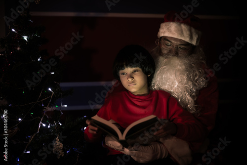 Santa clause reading tale for kid at christmas festival at home,Thailand people