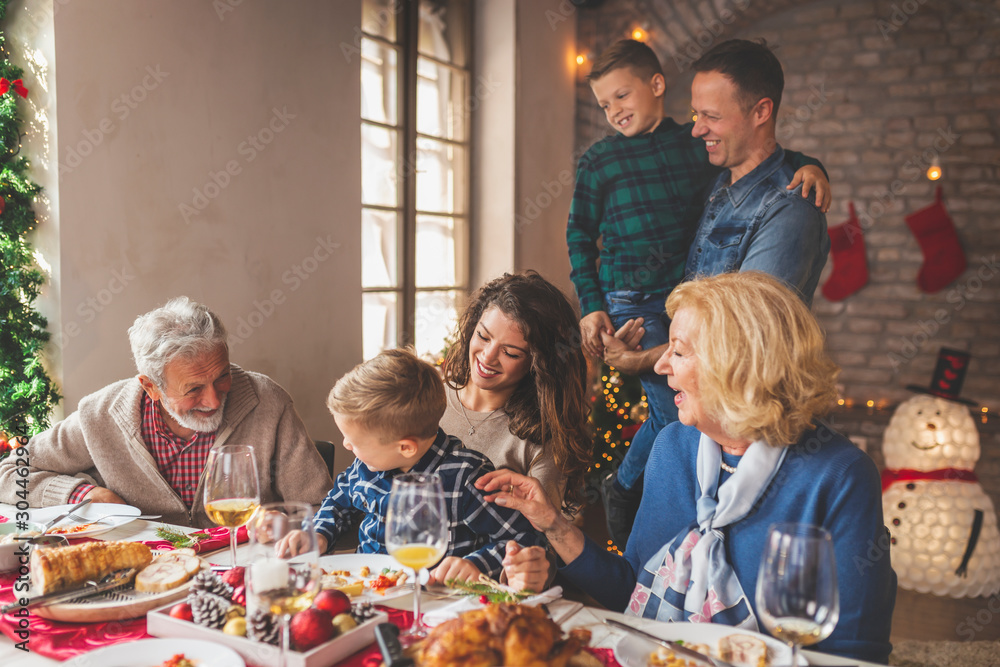 Family having Christmas dinner - obrazy, fototapety, plakaty 