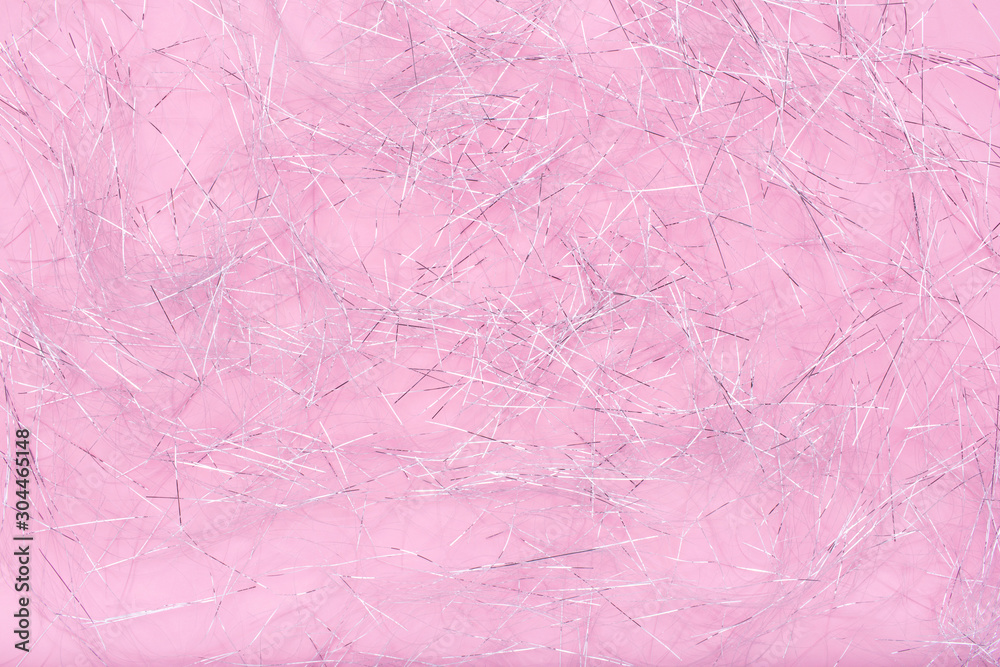 Glitter shreds. Sparkling shiny paper texture for Christmas. Silver shreds on pink background. Flat lay, copy space, top view. Winter holidays, New Year. Merry Christmas card. Space for text. Glitter shreds. Sparkling shiny paper texture for Christmas. Silver shreds on pink background. Flat lay, copy space, top view. Winter holidays, New Year. Merry Christmas card. Space for text.