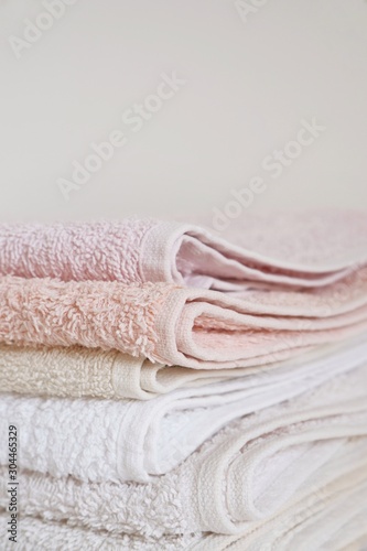 Close-up of clean cotton bath towels stacked. The concept of cleanliness and freshness. Selective focus. Copy space for text.