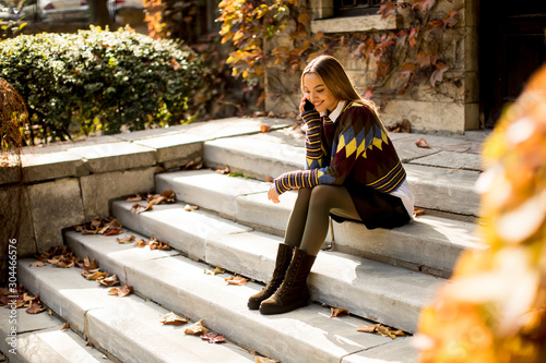 Young woman sitting on a st...