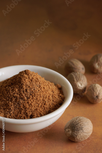 Whole and ground nutmeg a fragrant spice from the fruit of tree Myristica fragrans