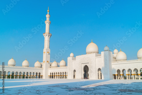 Panoramic view of Sheikh Zayed Grand Mosque, Abu Dhabi, United Arab Emirates. The third biggest mosque in the world. Blue sky sunny day.