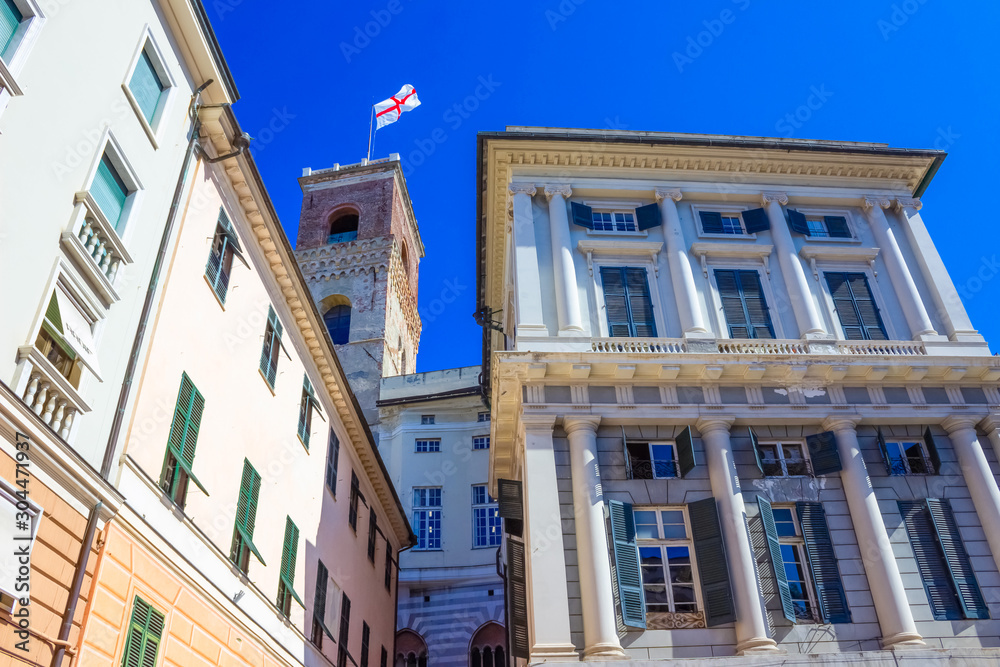 Facade of an old Italian building in old part of town, windows with shutters, old building in Genoa, Italy.