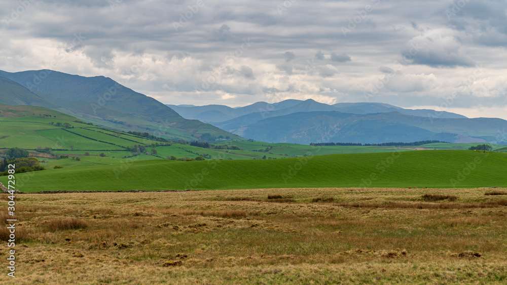 Looking at the Lake District National Park from a road between Caldbeck and Uldale, Cumbria, England, UK
