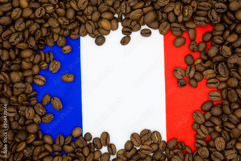 France flag placed under roasted coffee beans France flag placed under roasted coffee beans