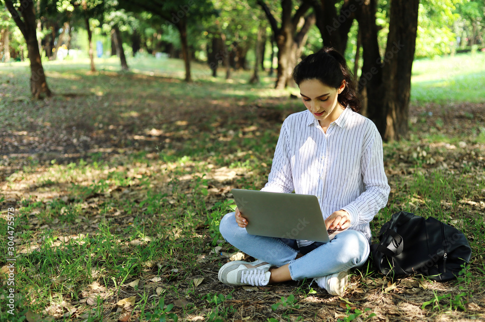 Beautiful girl smile portrait and looking laptop for work at public park in long holiday weekend. Beautiful girl smile portrait and looking laptop for work at public park in long holiday weekend.