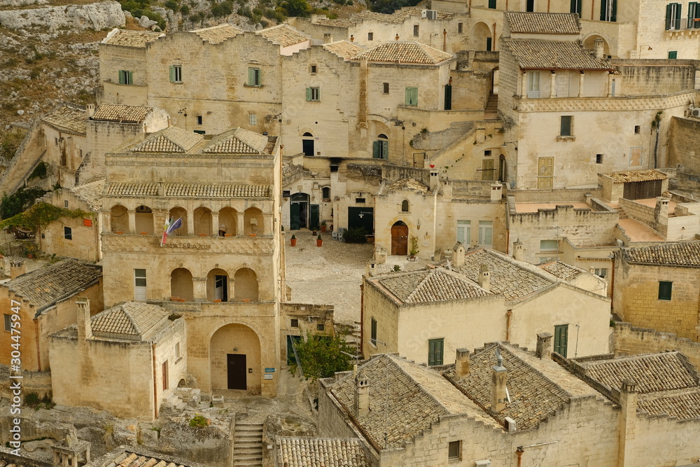 Houses and roofs of the city of Matera in Italy, world heritage of humanity. Homes built in beige tuff stone..
