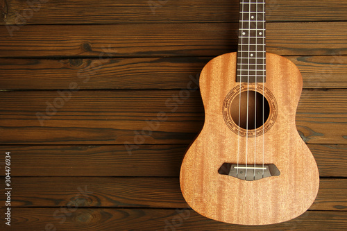 Ukulele on wooden background