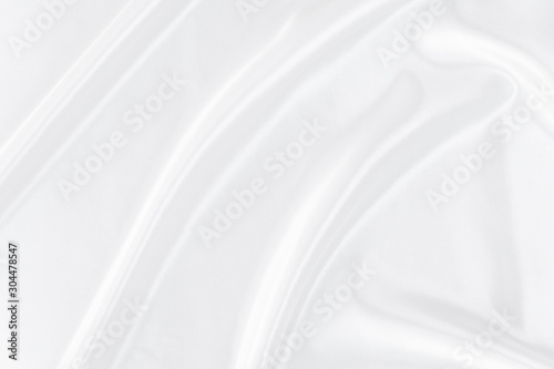 White gray satin texture that is white silver fabric silk background with beautiful soft blur pattern natural.