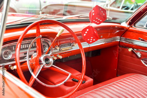 red interior dashboard of red vintage car