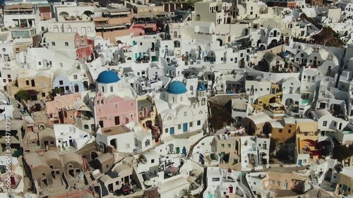 Flying Over Famous Blue Domed Church In Oia On Santorini Island In Greece