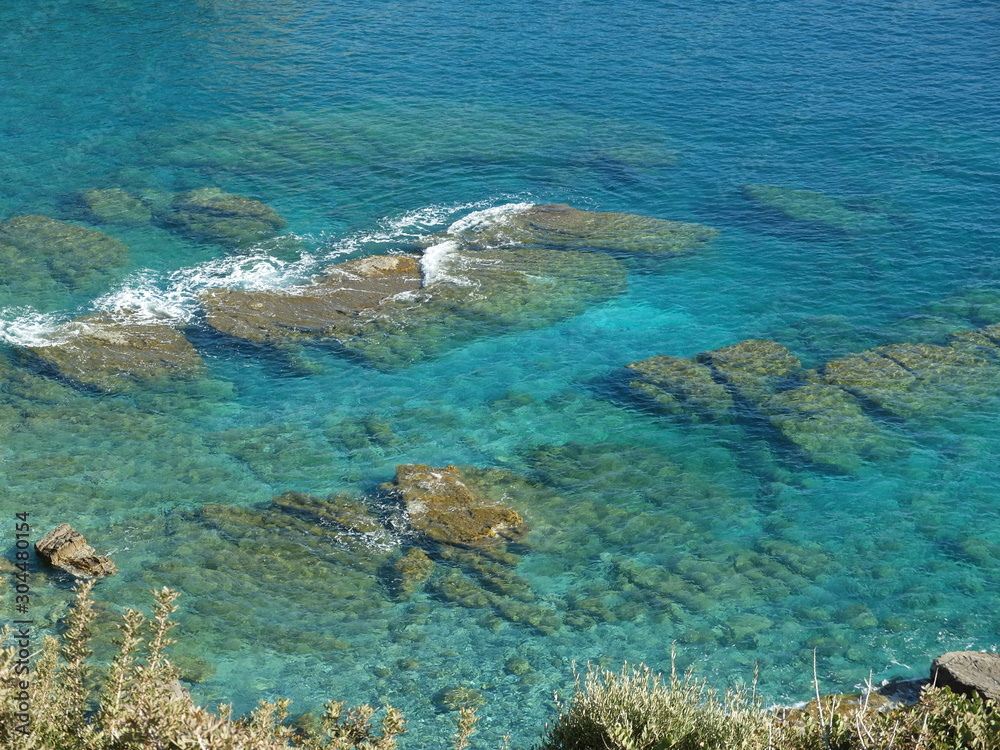 clear sea water with rocks and foam clear sea water with rocks and foam