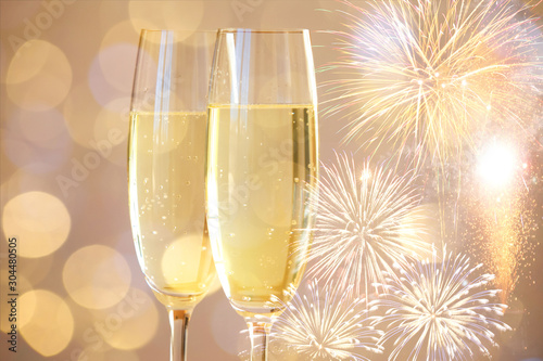 New year champagne glasses and fireworks background