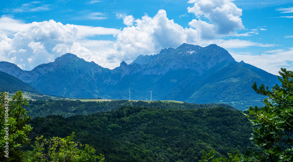 Panorama of beautiful countryside of France. Sunny day. Wonderful springtime landscape in mountains. Grassy field and rolling hills. Rural scenery. Amazing view Alps. Panorama of beautiful countryside of France. Sunny day. Wonderful springtime landscape in mountains. Grassy field and rolling hills. Rural scenery. Amazing view Alps.