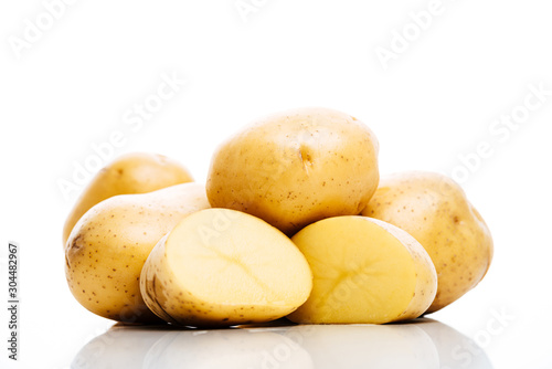 raw whole and cut fresh potatoes isolated on white