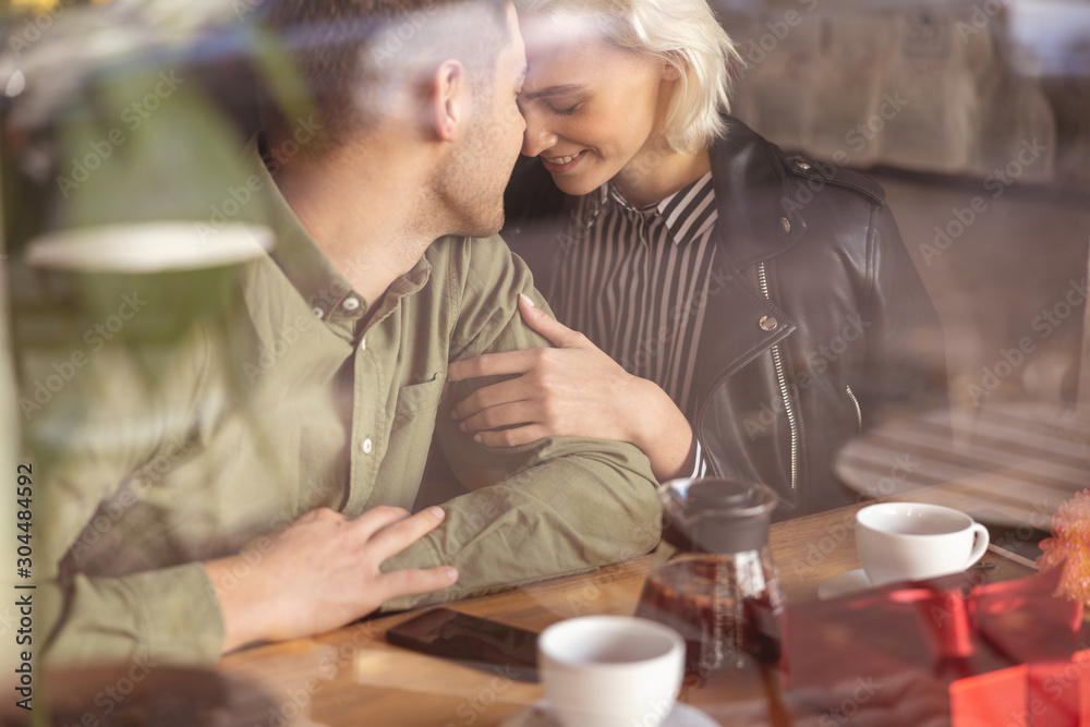Couple meeting in the cafe after a long break Couple meeting in the cafe after a long break
