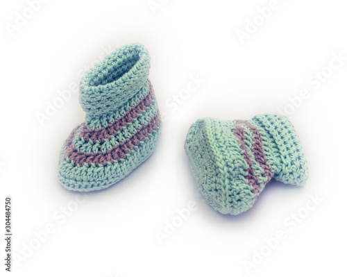 knitted baby booties on white
