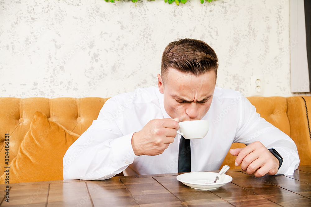 Businessman drinking a cup of coffee Businessman drinking a cup of coffee