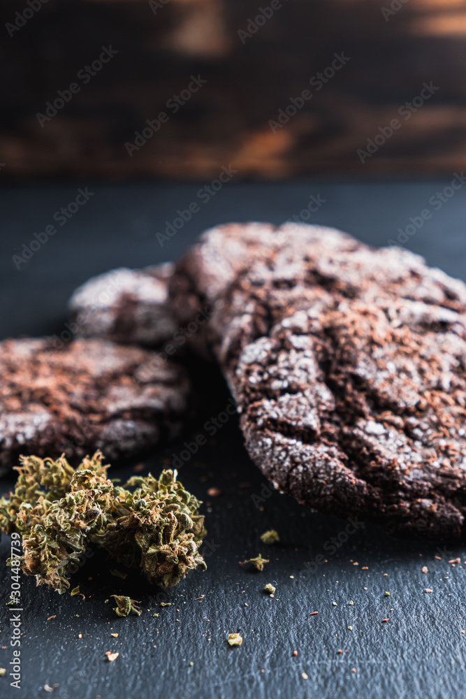 chocolate chip cookies with marijuana, sprinkled with chocolate chips and cannabis. Vertical chocolate chip cookies with marijuana, sprinkled with chocolate chips and cannabis. Vertical