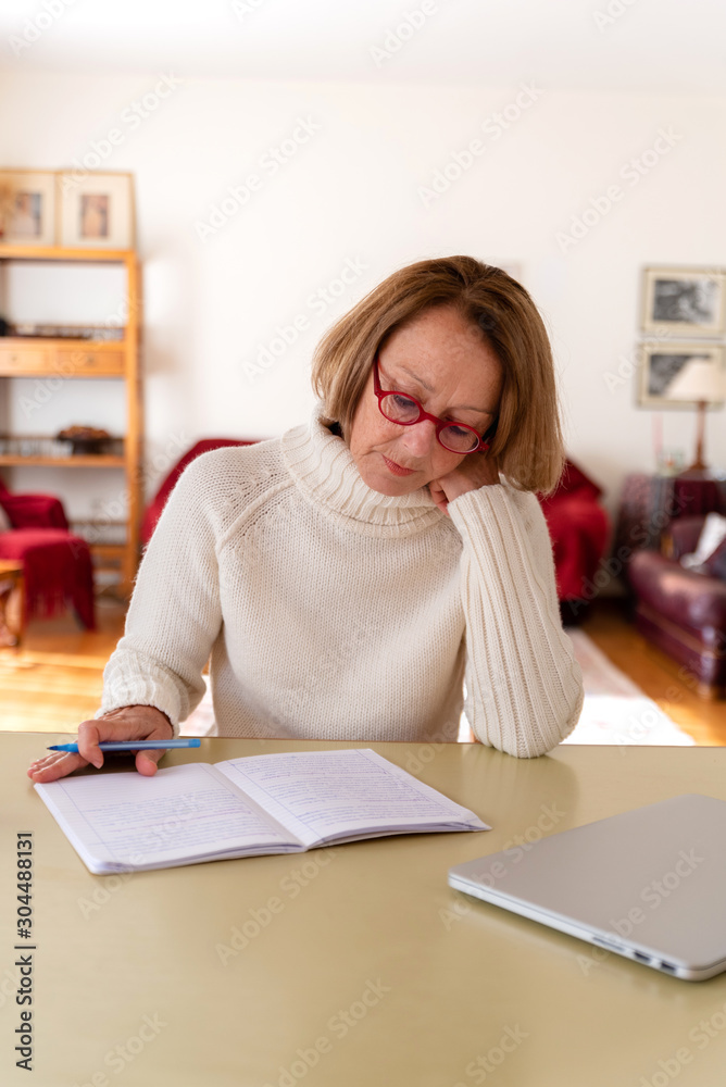 Middle age senior woman working at home using computer Middle age senior woman working at home using computer