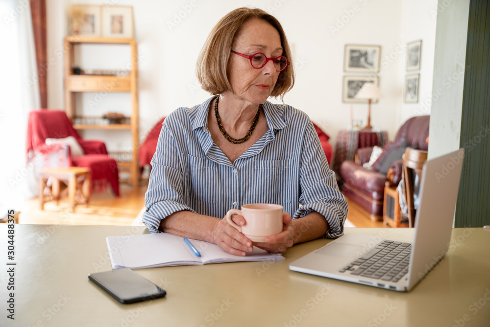 Middle age senior woman working at home using computer Middle age senior woman working at home using computer