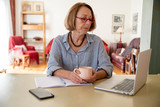 Middle age senior woman working at home using computer