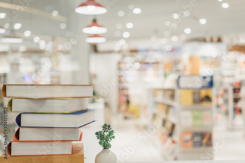 Book stack in the library room and blurred bookshelf background for business, education and back to school concept Fototapet