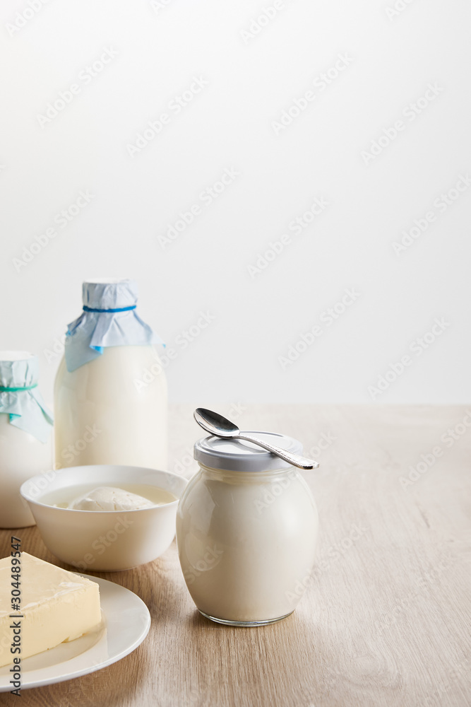 fresh organic dairy products on wooden table isolated on white