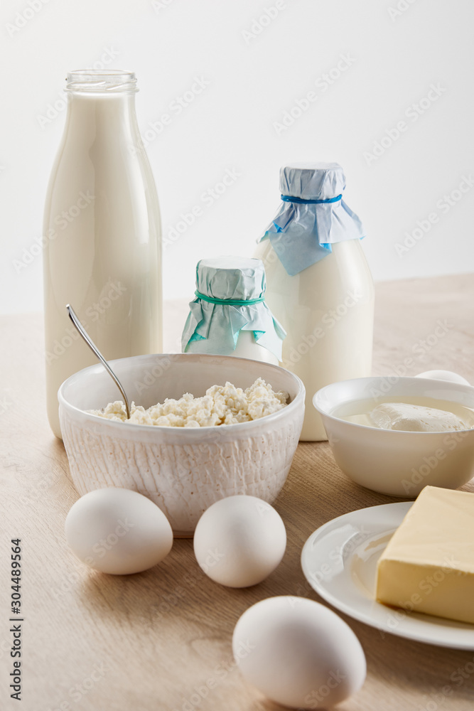 fresh organic dairy products and eggs on wooden table isolated on white fresh organic dairy products and eggs on wooden table isolated on white