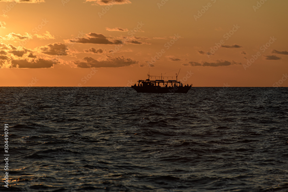 Fishing schooner at sunset