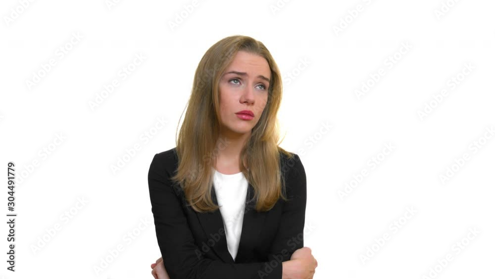 Anxious blonde business woman wearing business clothes. Pretty female manager or employee worried about her work environment, thinking deeply on isolated white background with copy space Anxious blonde business woman wearing business clothes. Pretty female manager or employee worried about her work environment, thinking deeply on isolated white background with copy space