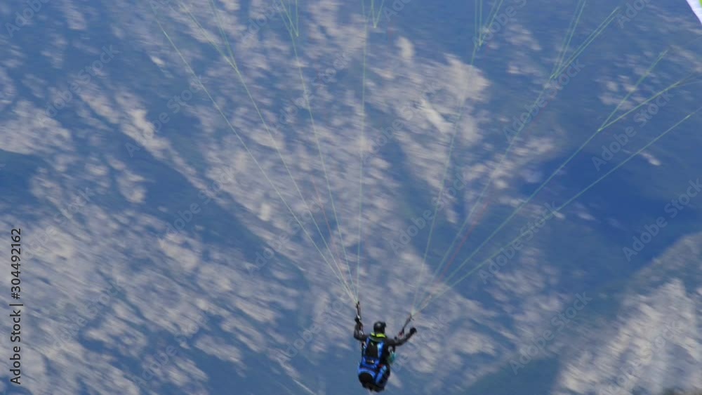 Paraglider flying over the Garda Lake (Lago di Garda or Lago Benaco). Paragliding on Monte Baldo. Panorama of the gorgeous Garda lake surrounded by mountains, Malcesine, Italy Paraglider flying over the Garda Lake (Lago di Garda or Lago Benaco). Paragliding on Monte Baldo. Panorama of the gorgeous Garda lake surrounded by mountains, Malcesine, Italy