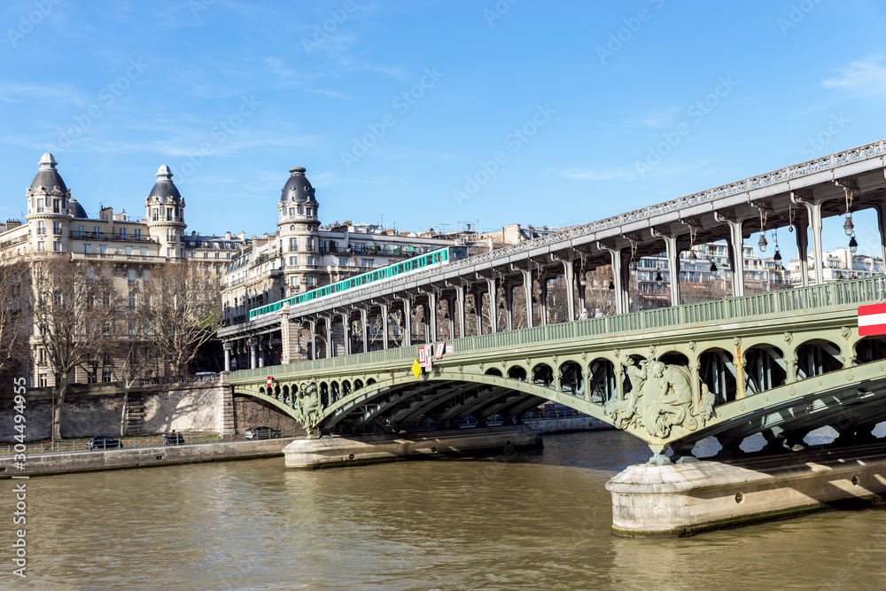 Paris, France: Metro traffic on Pont Bir-Hakeim (Passy viaduc) with view over Passy station buildings - Paris, France
